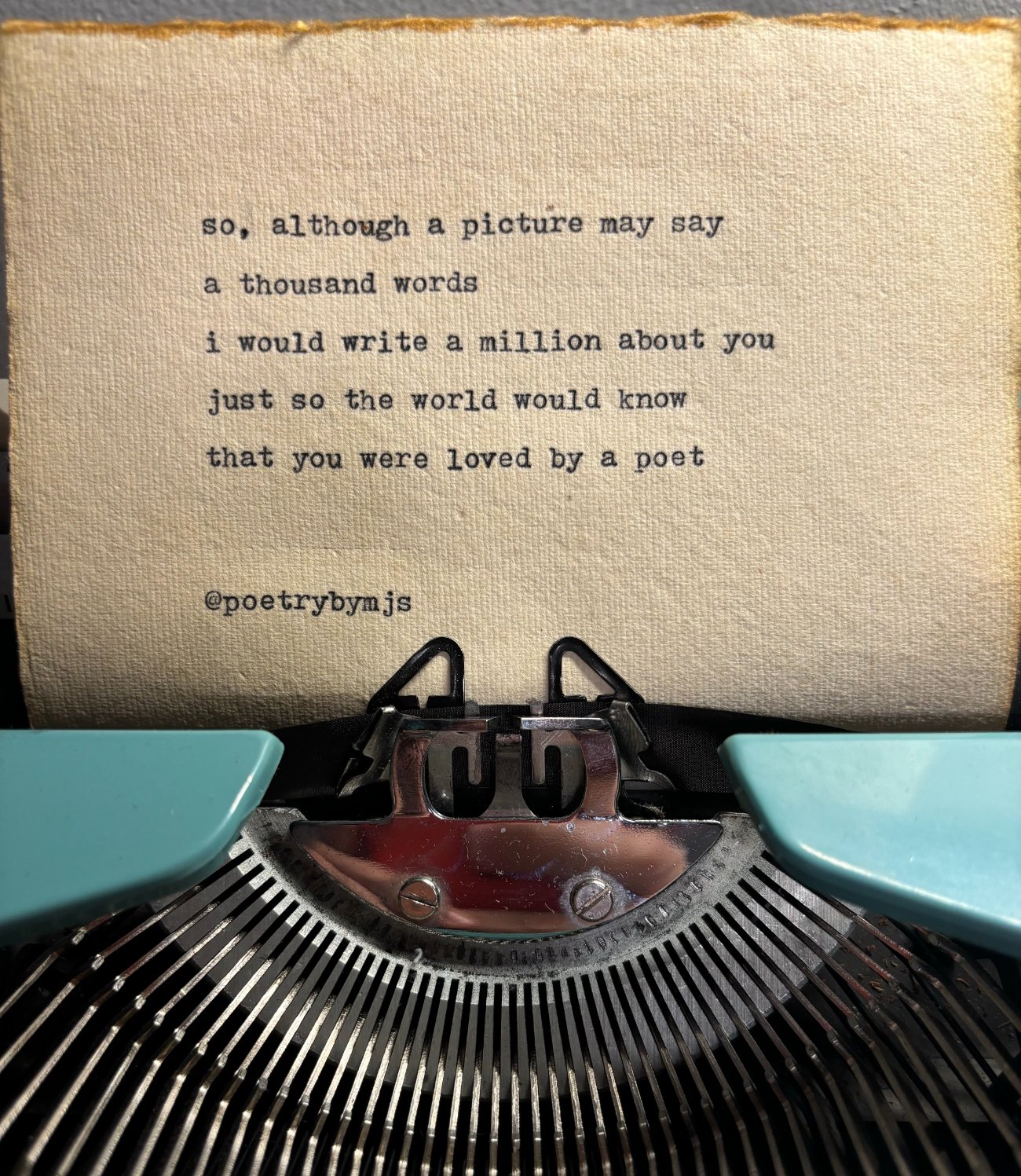 An original poem typed on a vintage teal typewriter